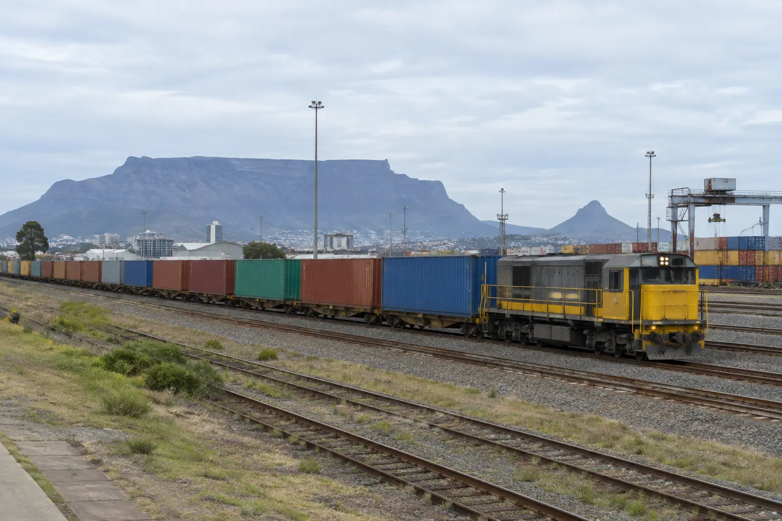Freight train loaded with containers in a South African rail yard