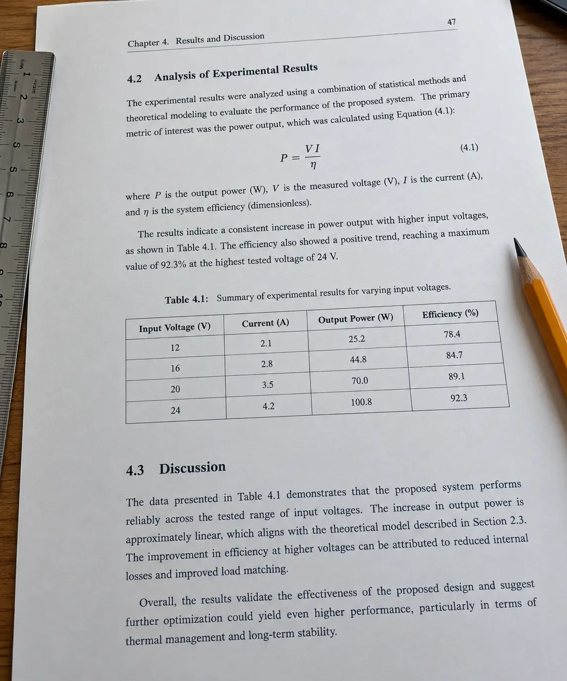 Close-up of a printed engineering dissertation page with a numbered equation and a captioned data table