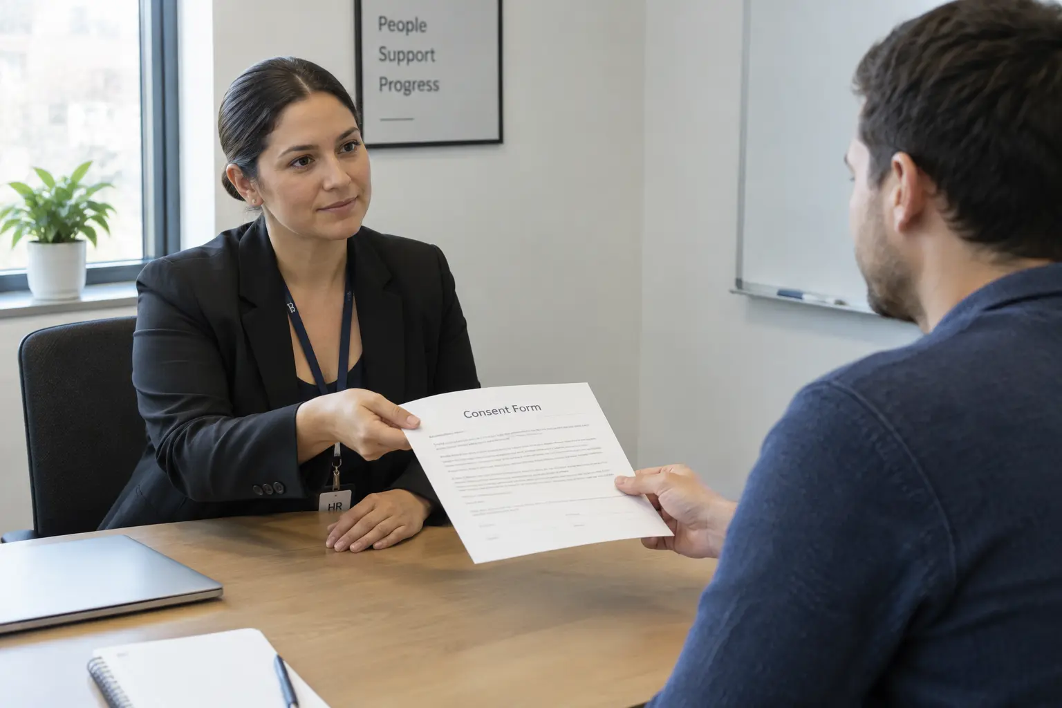 An HR representative handing a printed consent form to an employee in a small meeting room, illustrating neutral third-party recruitment